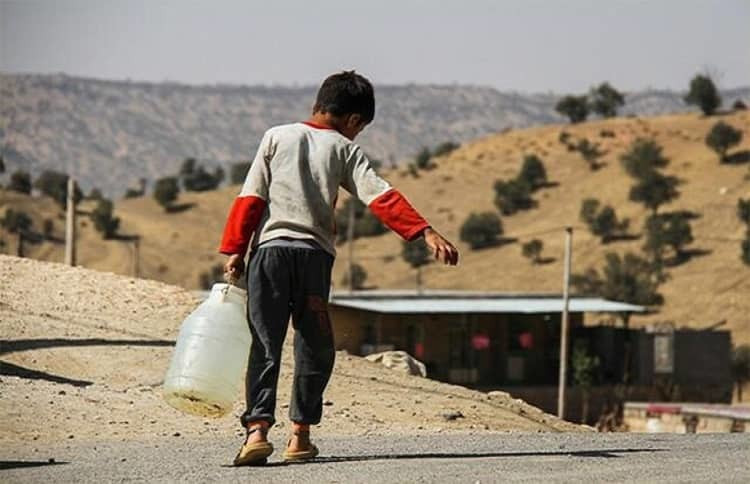 A boy in Khuzestan, Iran carrying water in the midst of draught